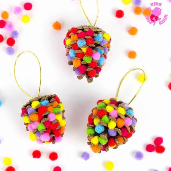 This colourful Pom Pom Pinecone craft for kids looks great! Use this nature craft to make Christmas ornaments or as pretty mobiles all year. There's even a fun idea for a colourful pinecone math game too.