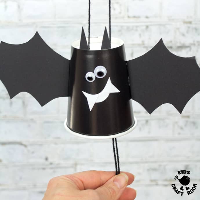 PAPER CUP FLYING BAT CRAFT - These paper cup flying bats are really quick and easy to make so it's a great craft to do with kids of all ages from toddlers to tweens. Built around a paper cup these little bats cleverly fly up and down when you pull the strings. Such a fun Halloween craft for kids. #bat #bats #batcrafts #halloween #halloweencrafts #papercups #papercupcrafts #kidscrafts #kidscraftroom #halloweendecorations