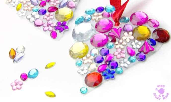 JEWELLED HEART SUNCATCHERS are so pretty! This is an easy recycled craft for kids and they make lovely gifts too. A great kids craft for Valentine's Day, Mother's Day and Summer. #valentine #valentinesday #valentinesdaycraft #valentinecraft #valentinescrafts #valentinecrafts #valentinesdayforkids #heart #love #heartcrafts #upcycledcraft #recycledcraft #suncatchers #suncatchercrafts #kidsart #ECE #kidscrafts #kidscraft #kidscrafts101 #craftsforkids #preschool #preK #earlyyears