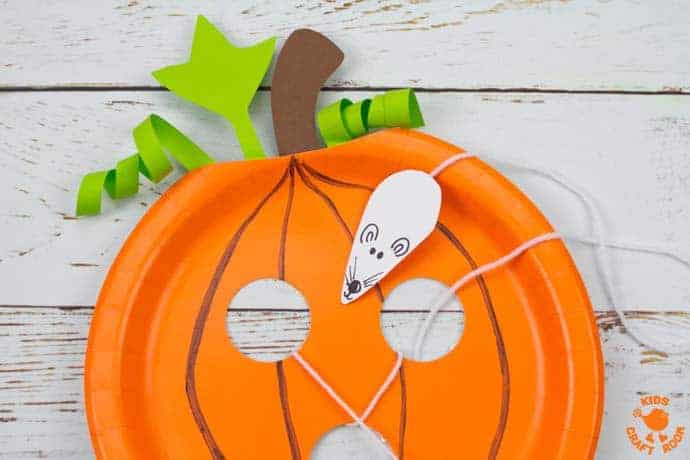 This Paper Plate Pumpkin Lacing Craft is loads of fun! Kids will love lacing the mouse through the holes in the pumpkin that the cheeky fellow has nibbled! An interactive paper plate pumpkin craft for toddlers and preschoolers. A fun non scary Halloween craft for kids. #halloween #halloweencrafts #pumpkins #pumpkincrafts #kidscrafts #craftsforkids #kidscraft #fallcrafts #autumncrafts #paperplates #paperplatecrafts #kidscraftroom