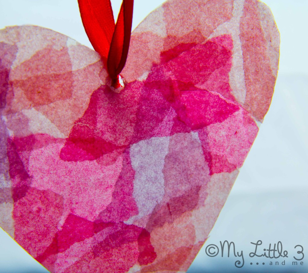 STAINED GLASS HEART SUNCATCHERS are so pretty. This is an easy and fun Valentine's Day craft for kids. They make lovely Valentine decorations and Valentine gifts and they're great as a Mother's Day craft idea too. #kidscraftroom #valentinesday #valentines #valentinecrafts #valentinesgifts #valentinesdaydecorations #kidscrafts #mothersday #mothersdaycrafts #heartcrafts #recycledcrafts via @KidsCraftRoom